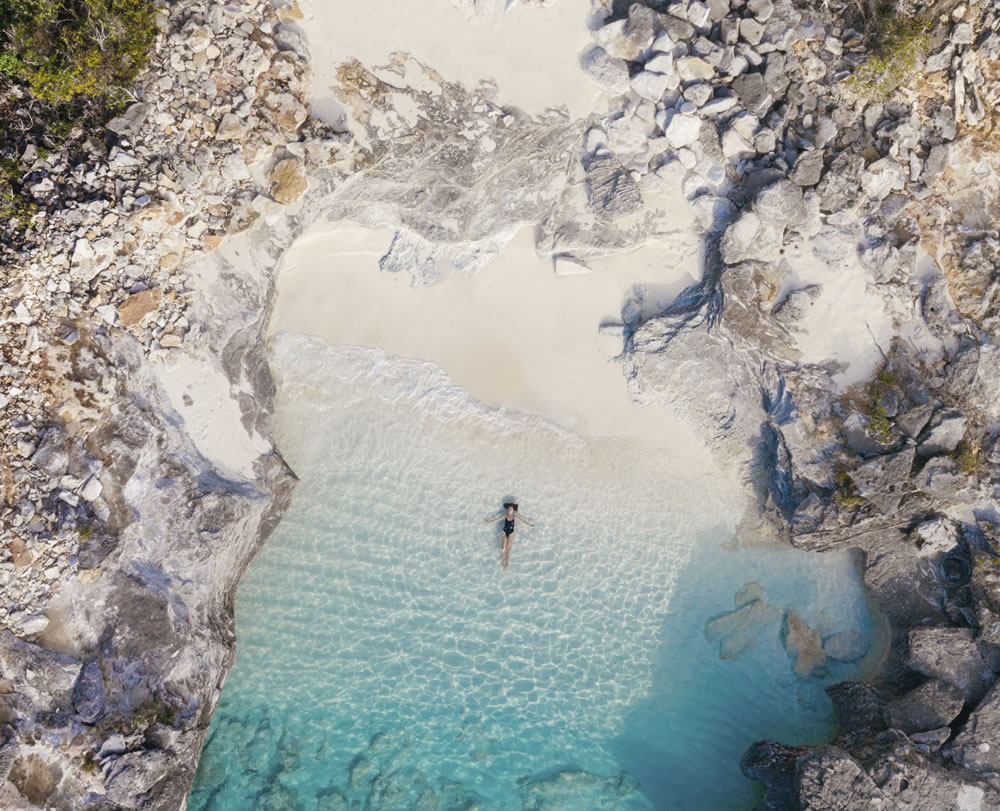 woman in sea on private beach